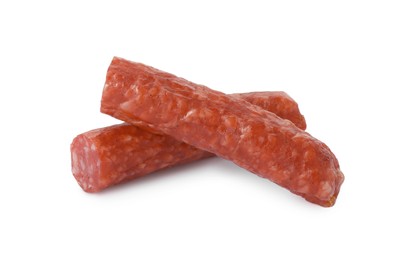 Photo of Pieces of thin dry smoked sausage isolated on white