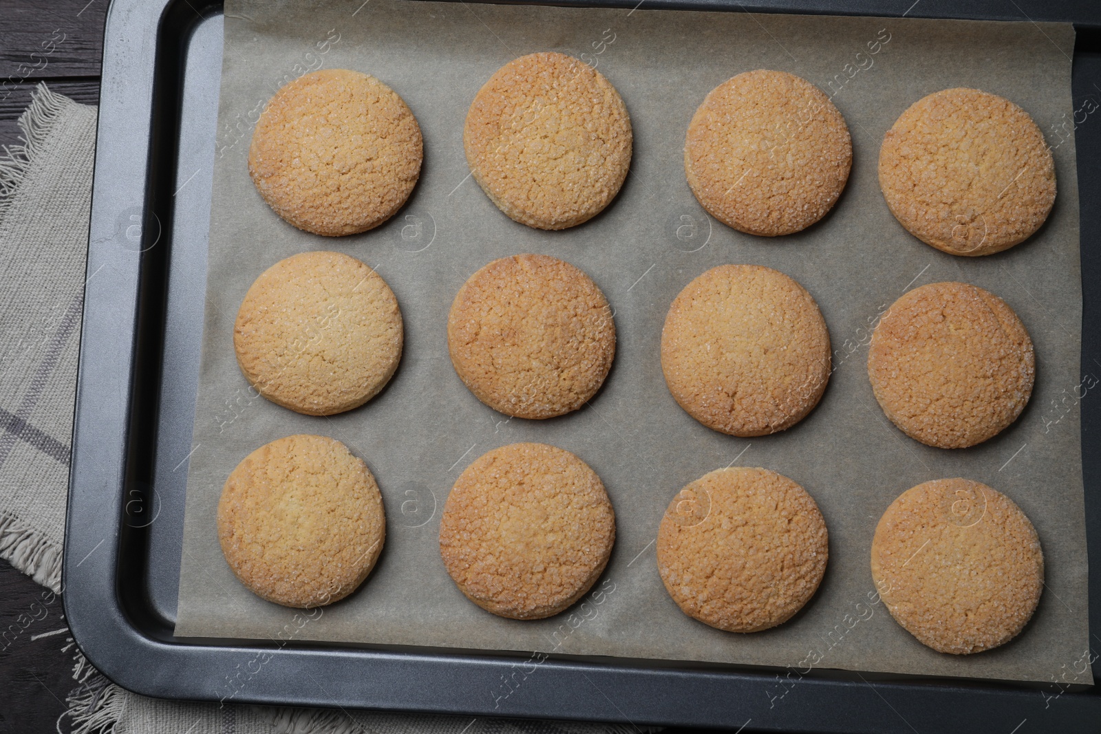 Photo of Baking sheet with delicious sugar cookies on table, top view