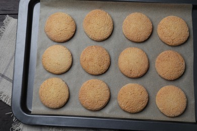 Photo of Baking sheet with delicious sugar cookies on table, top view