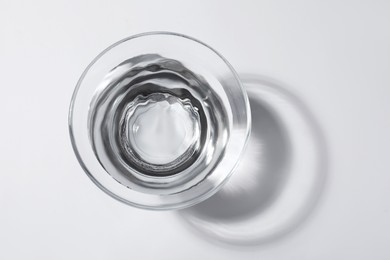 Photo of Glass bowl with water on white background, top view