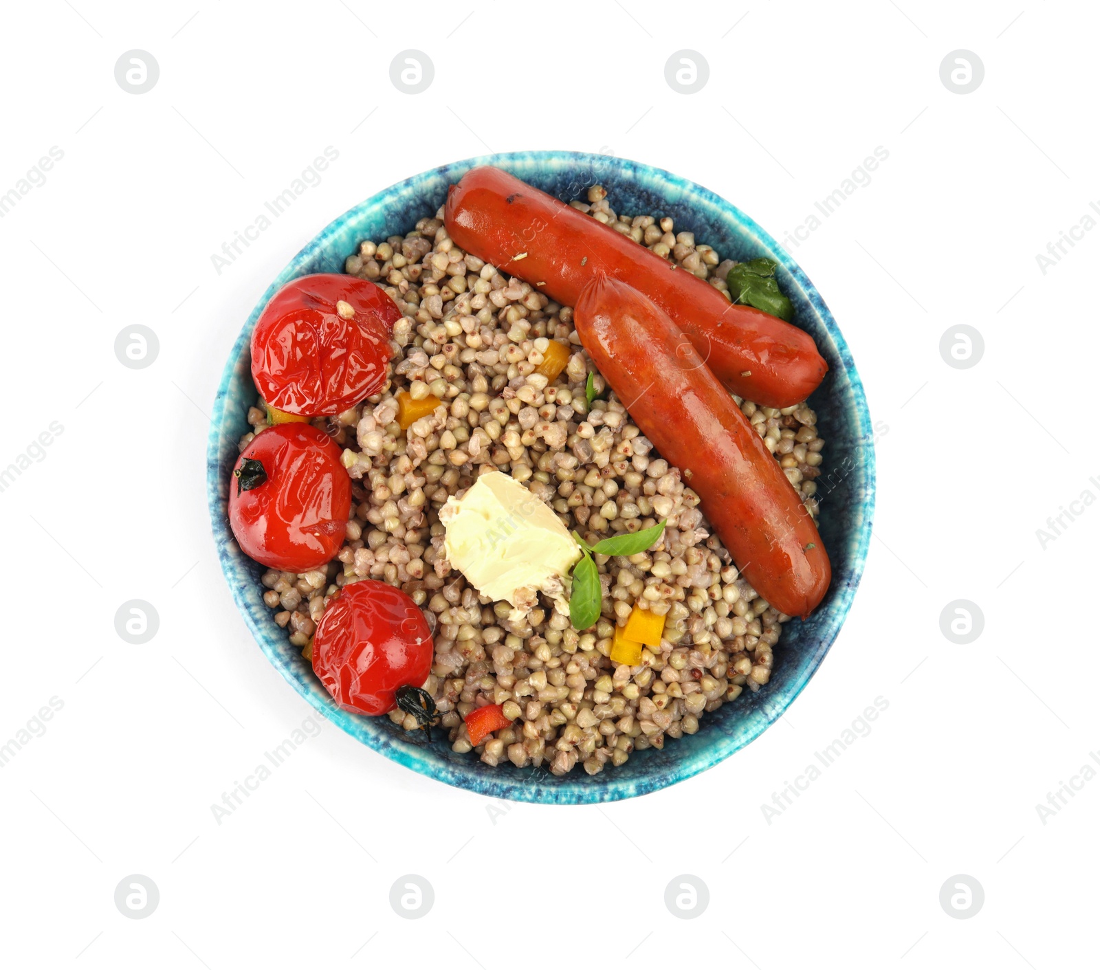 Photo of Tasty buckwheat porridge with sausages and vegetables isolated on white, top view