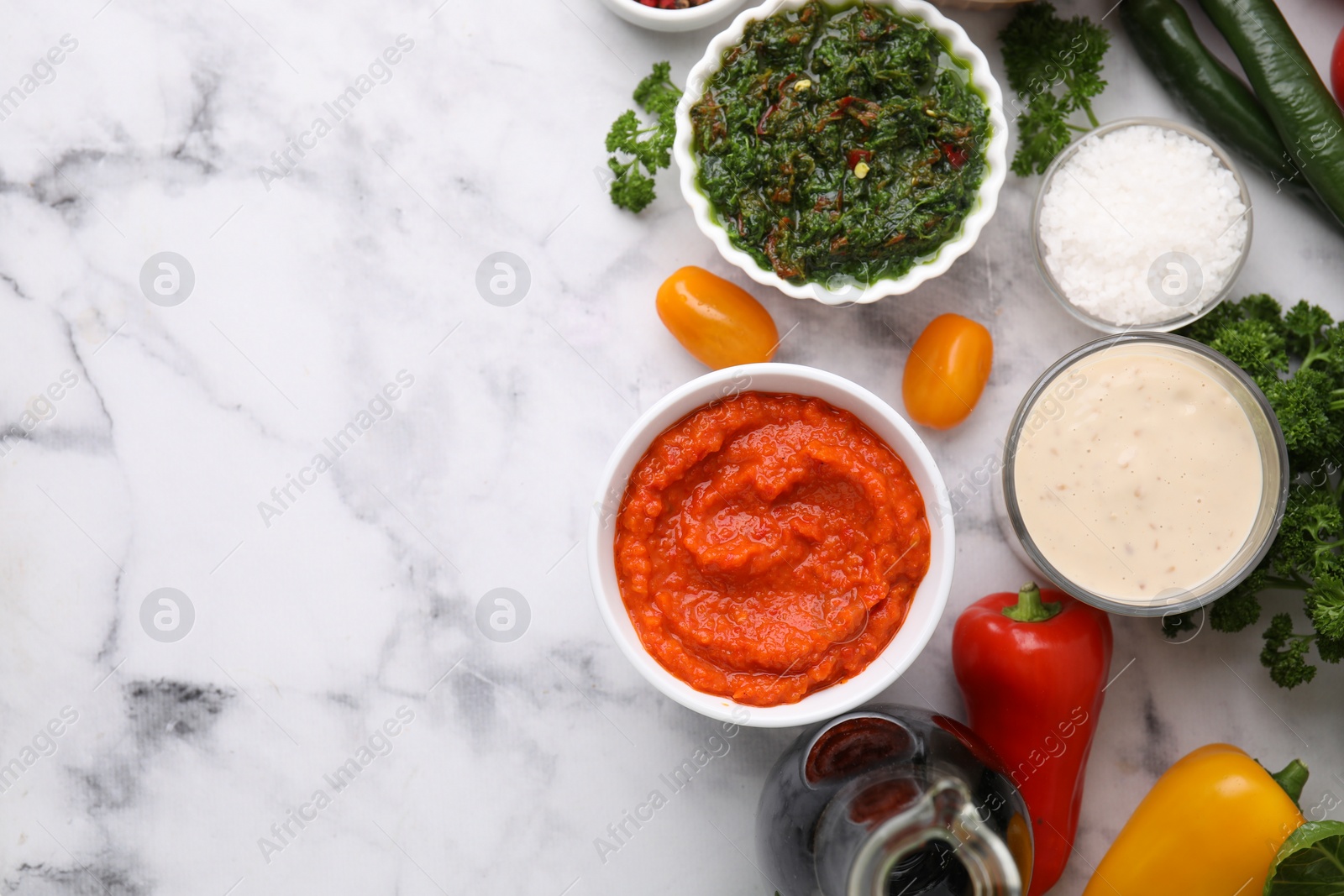 Photo of Different marinades and products on white marble table, flat lay. Space for text