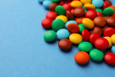 Tasty colorful candies on blue background, closeup. Space for text