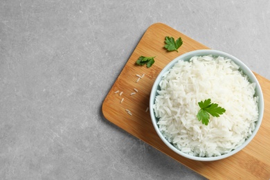 Photo of Bowl of delicious rice on table, top view with space for text