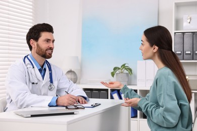 Doctor consulting patient during appointment in clinic