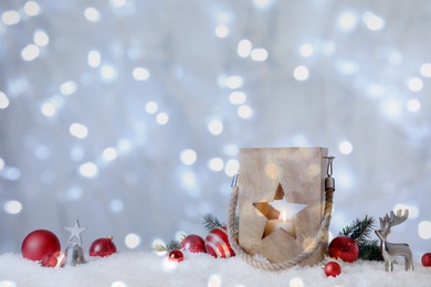Composition with wooden Christmas lantern on snow, space for text. Bokeh effect