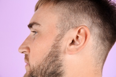 Young man on color background, closeup. Hearing problem