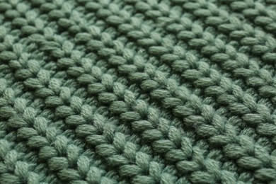 Photo of Beautiful pale green knitted fabric as background, closeup