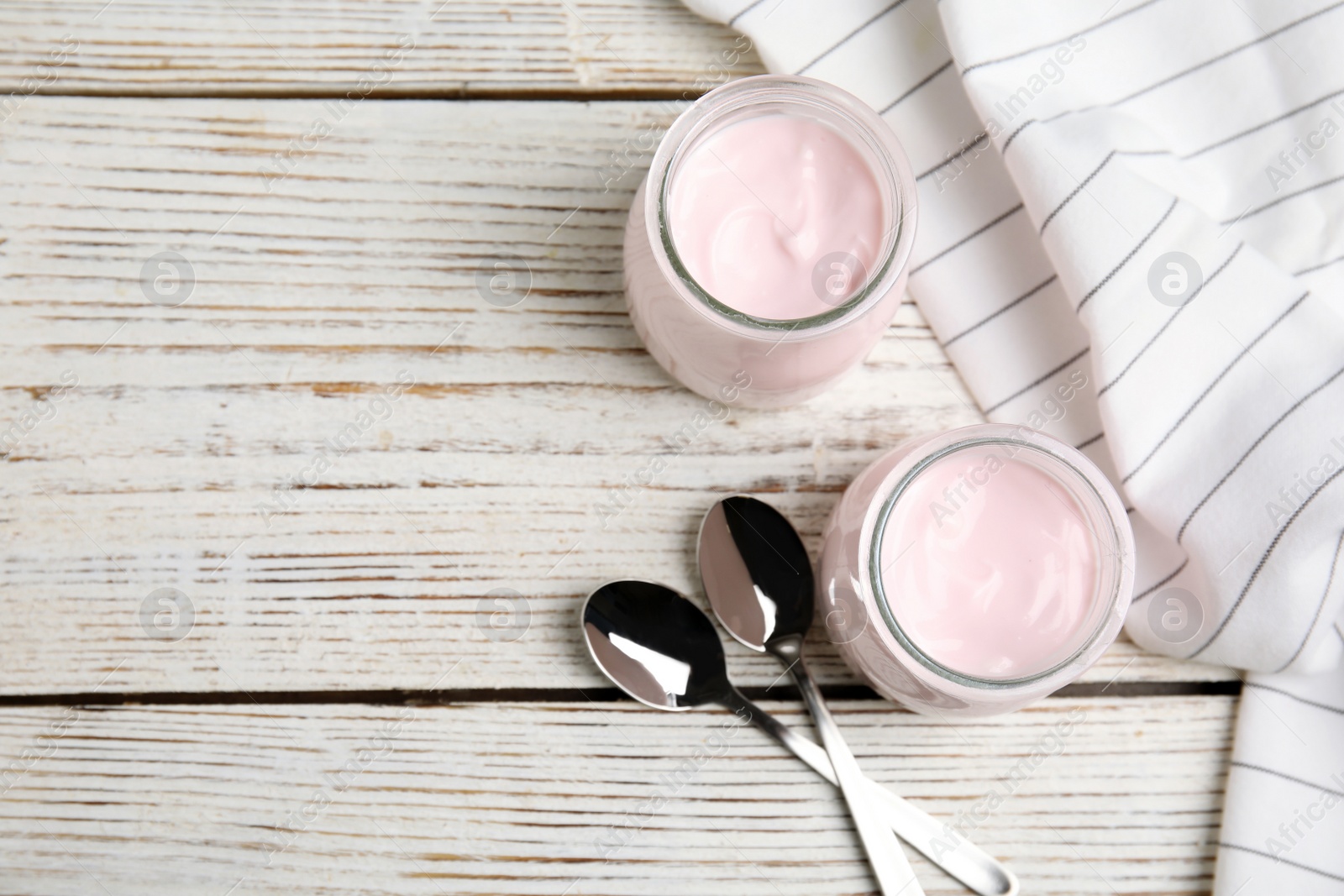 Photo of Flat lay composition with creamy yogurt and space for text on white wooden background