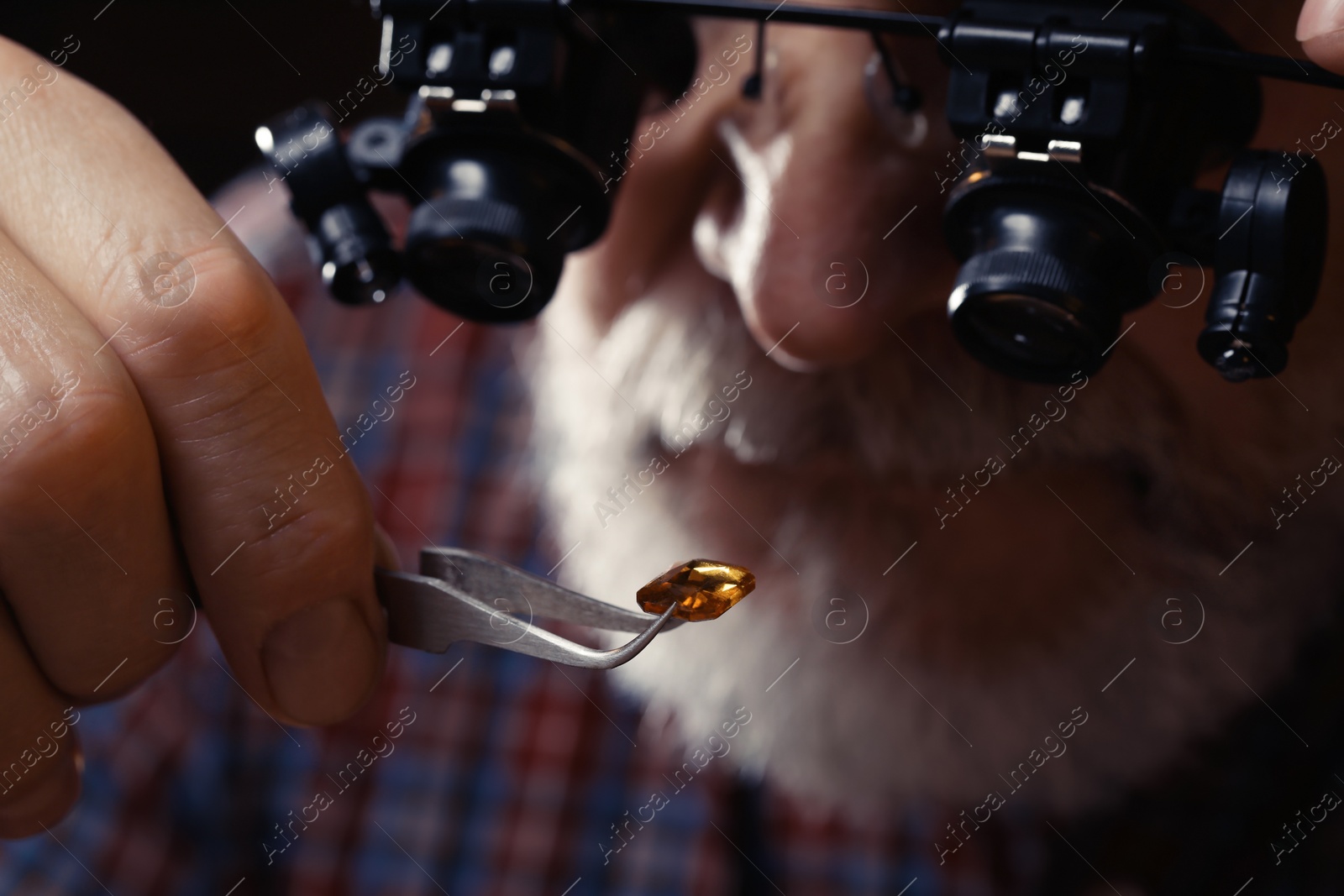 Photo of Professional jeweler working with gemstone, closeup view