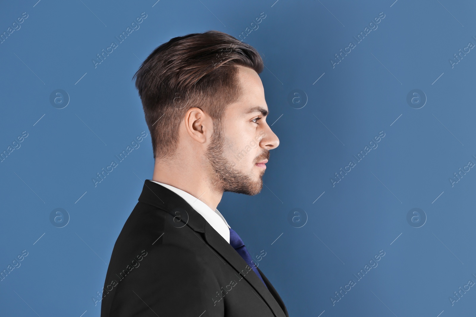 Photo of Portrait of young man with beautiful hair on color background