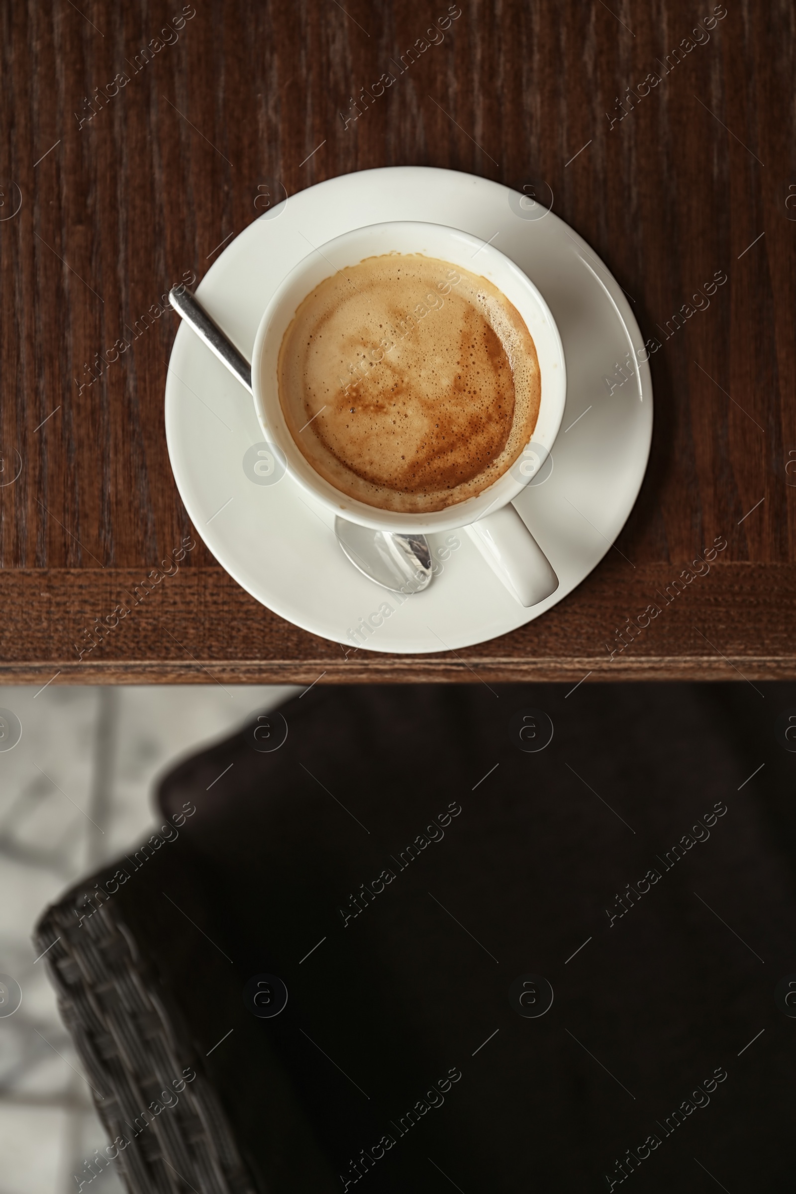 Photo of Cup of delicious aromatic coffee on table, top view