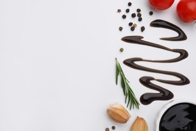 Organic balsamic vinegar and cooking ingredients on white background, flat lay. Space for text