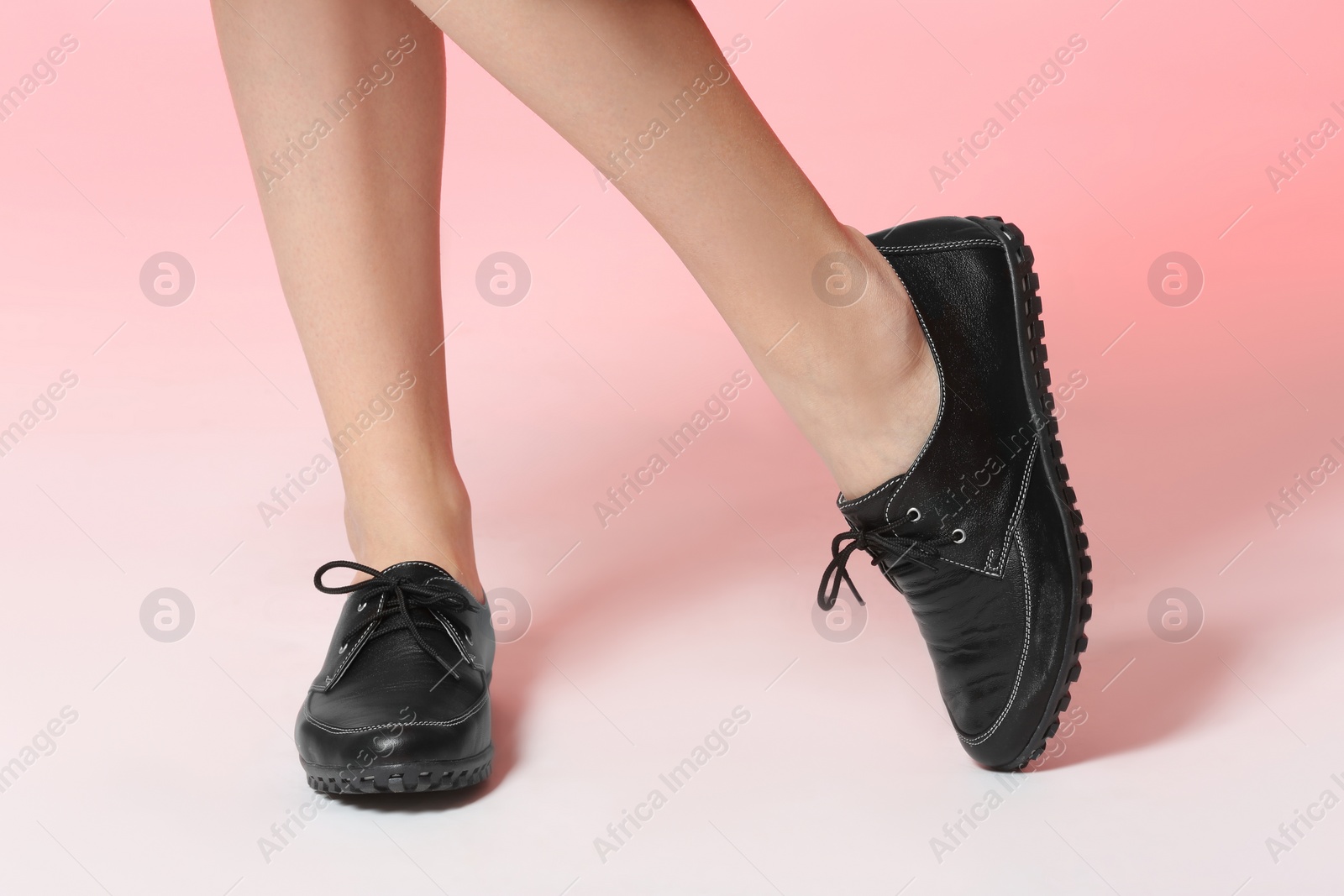 Photo of Woman in stylish shoes on color background, closeup