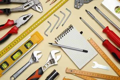 Flat lay composition with different tools on beige background