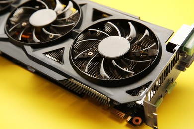 Photo of One graphics card on yellow background, closeup