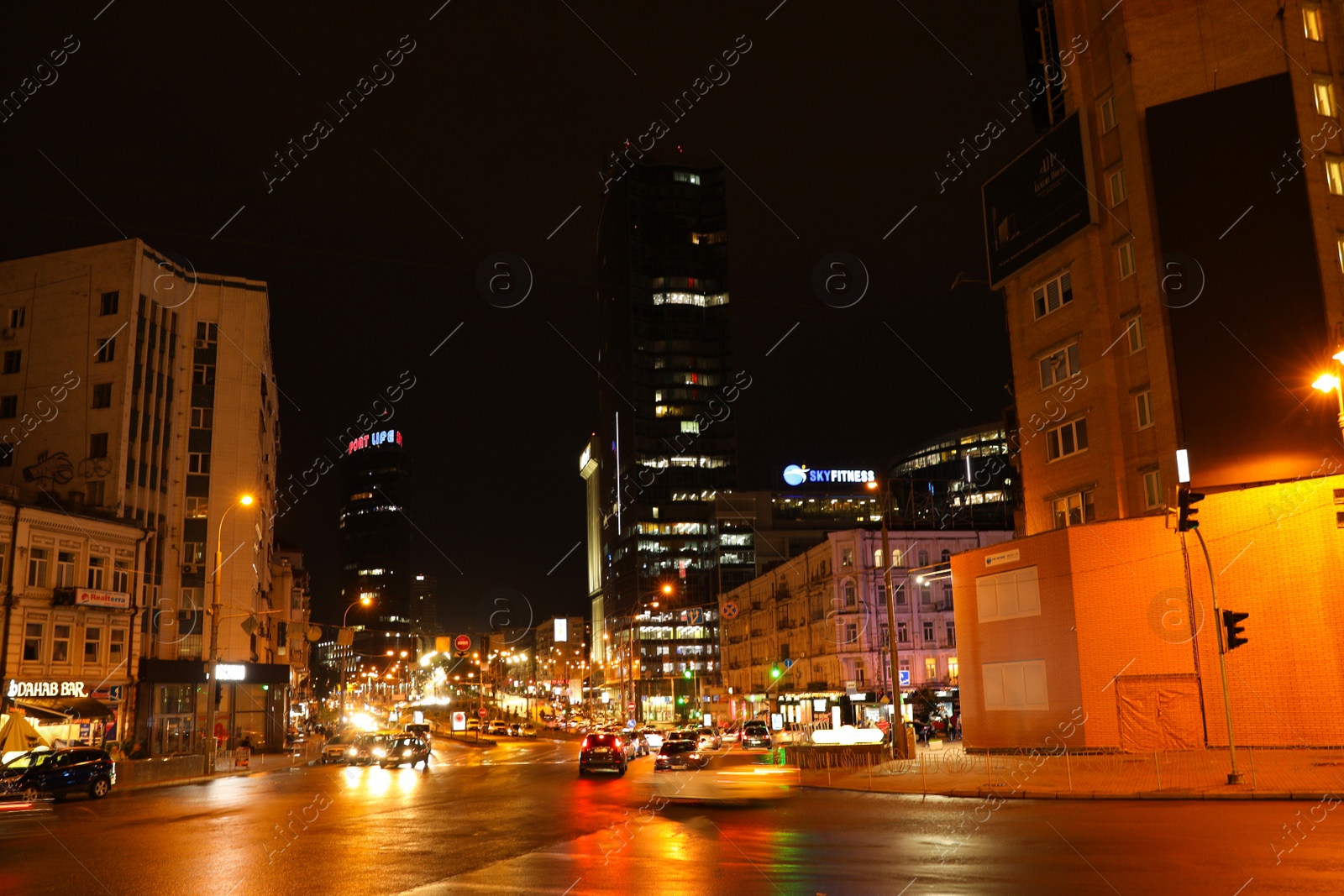 Photo of KYIV, UKRAINE - MAY 22, 2019: View of night city with illuminated buildings and road traffic