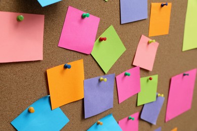 Photo of Many blank colorful notes pinned to corkboard