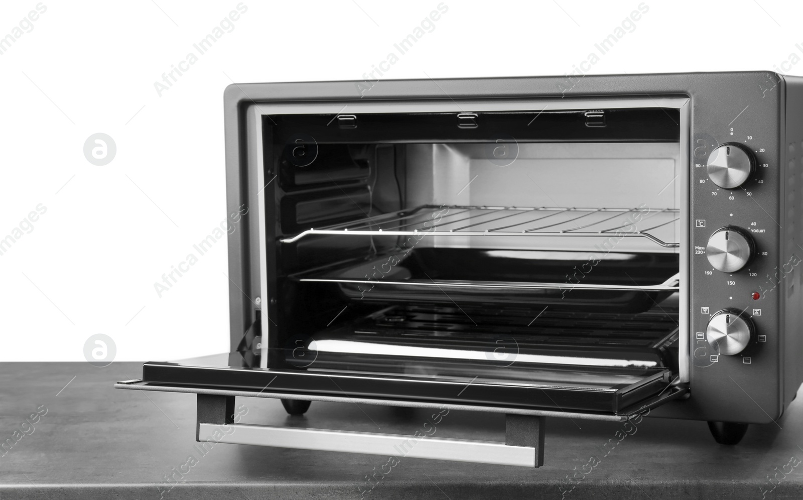 Photo of One electric oven on grey table against white background