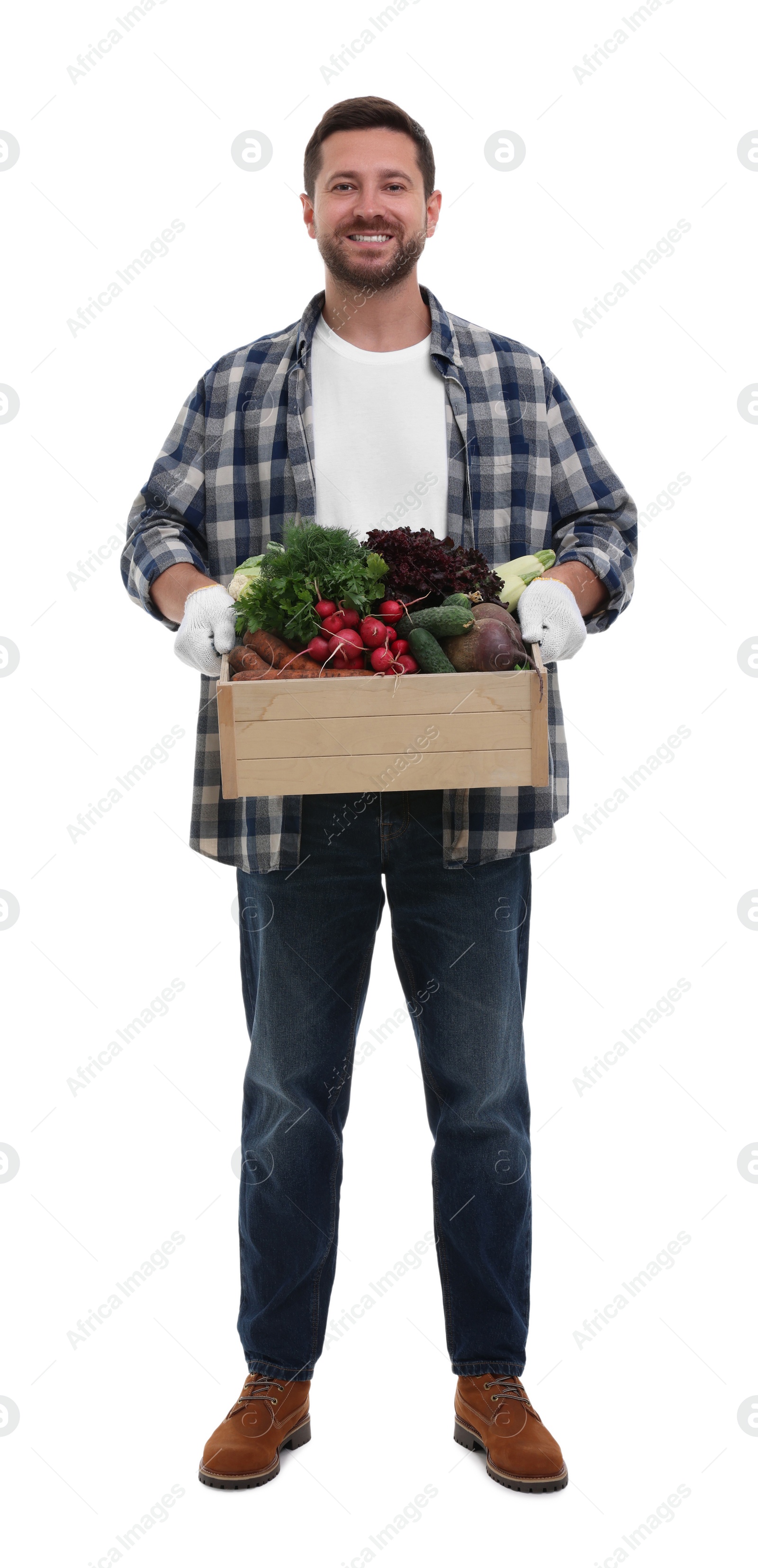 Photo of Harvesting season. Happy farmer holding wooden crate with vegetables on white background