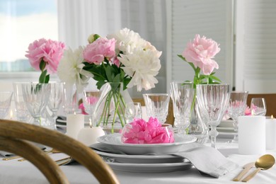 Photo of Stylish table setting with beautiful peonies in dining room