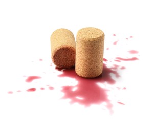 Photo of Bottle corks with wine stains on white background