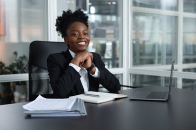 Happy woman working at table in office. Lawyer, businesswoman, accountant or manager