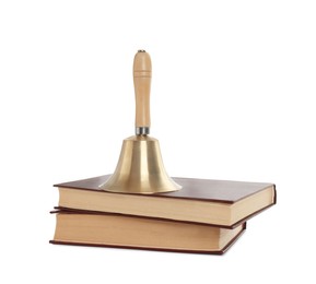 Photo of Golden school bell with wooden handle and books on white background