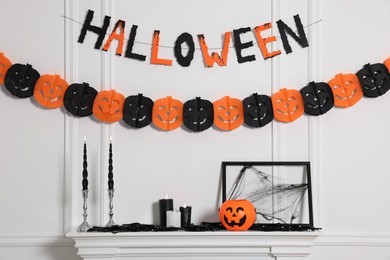 Photo of Different Halloween decor near white wall indoors