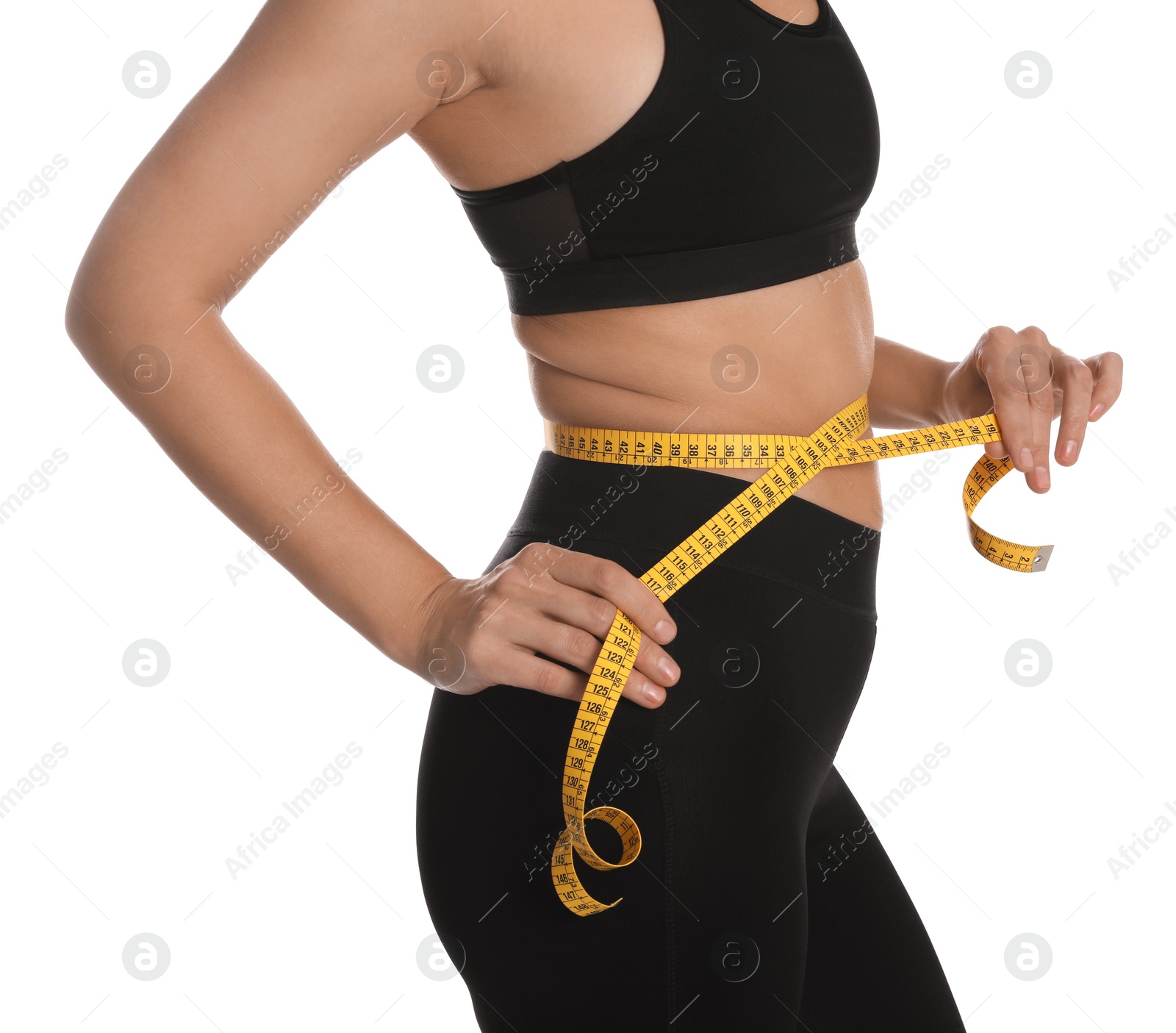 Photo of Woman measuring waist with tape on white background, closeup