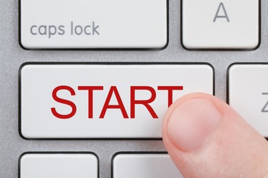 Woman pressing button with word Start on computer keyboard, closeup