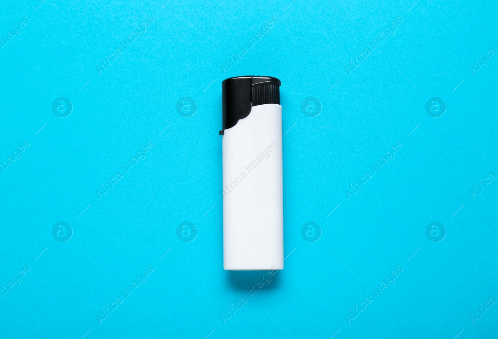 Photo of White plastic cigarette lighter on light blue background, top view