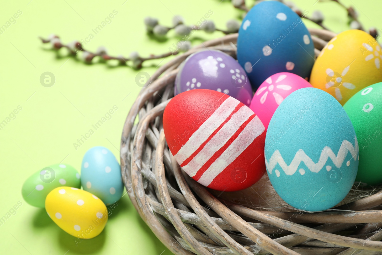 Photo of Composition with Easter eggs on green background, closeup