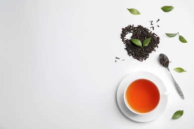 Flat lay composition with delicious tea on light background