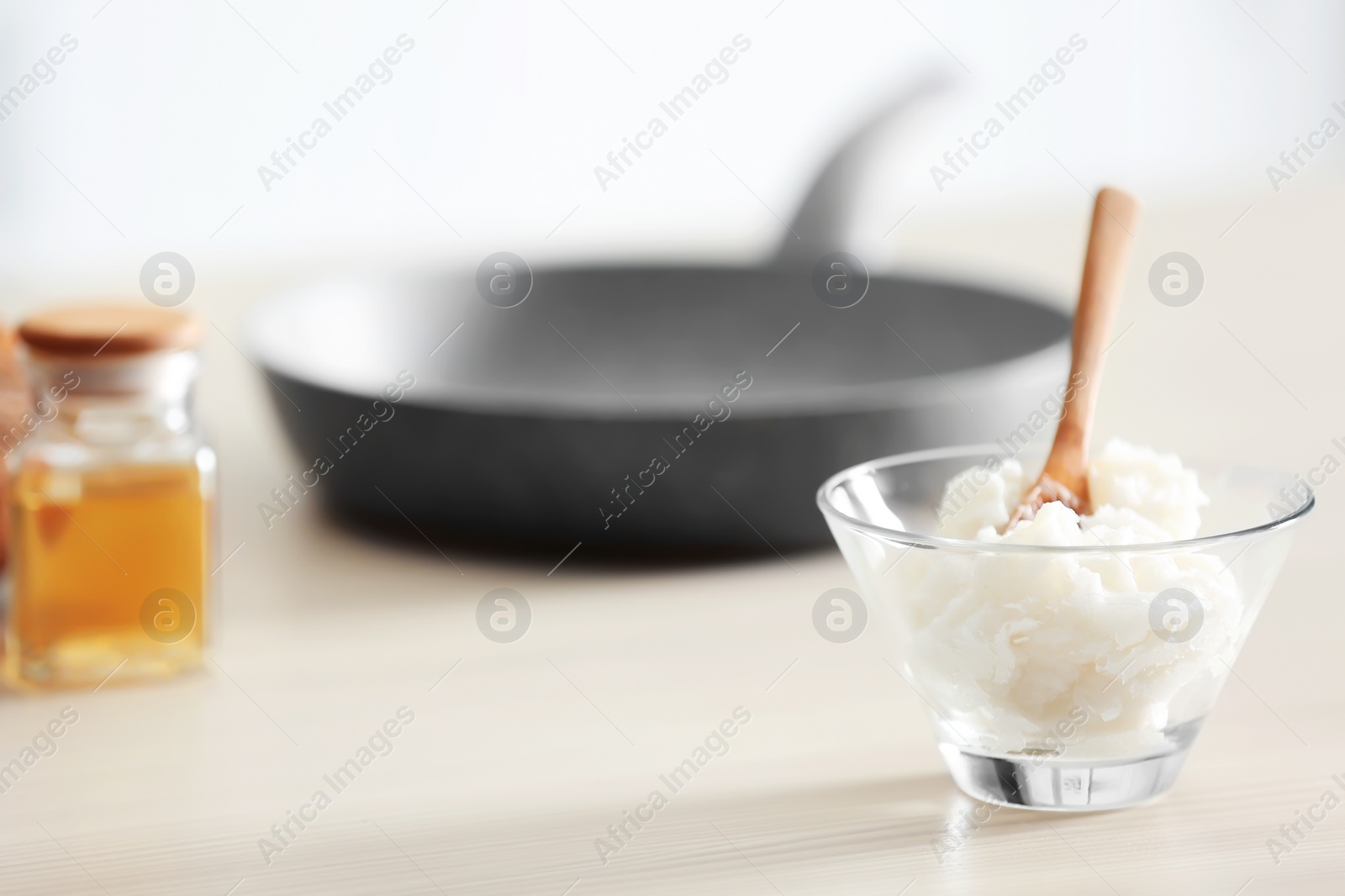 Photo of Bowl with coconut oil on kitchen table