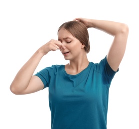 Photo of Young woman with sweat stain on her clothes against white background. Using deodorant