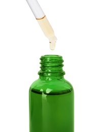 Photo of Green bottle and dropper with essential oil on white background