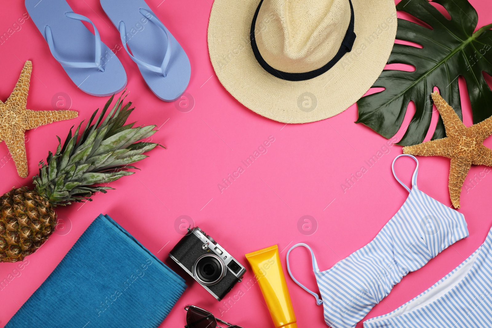 Photo of Frame of beach objects on pink background, flat lay. Space for text