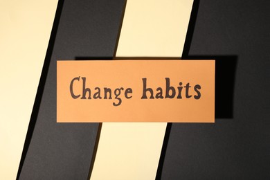 Photo of Paper note with phrase Change Habits on color background, top view