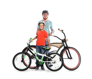 Portrait of father and his son with bicycles on white background