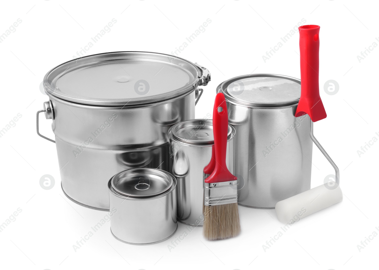 Photo of New metal paint cans, brush and roller on white background