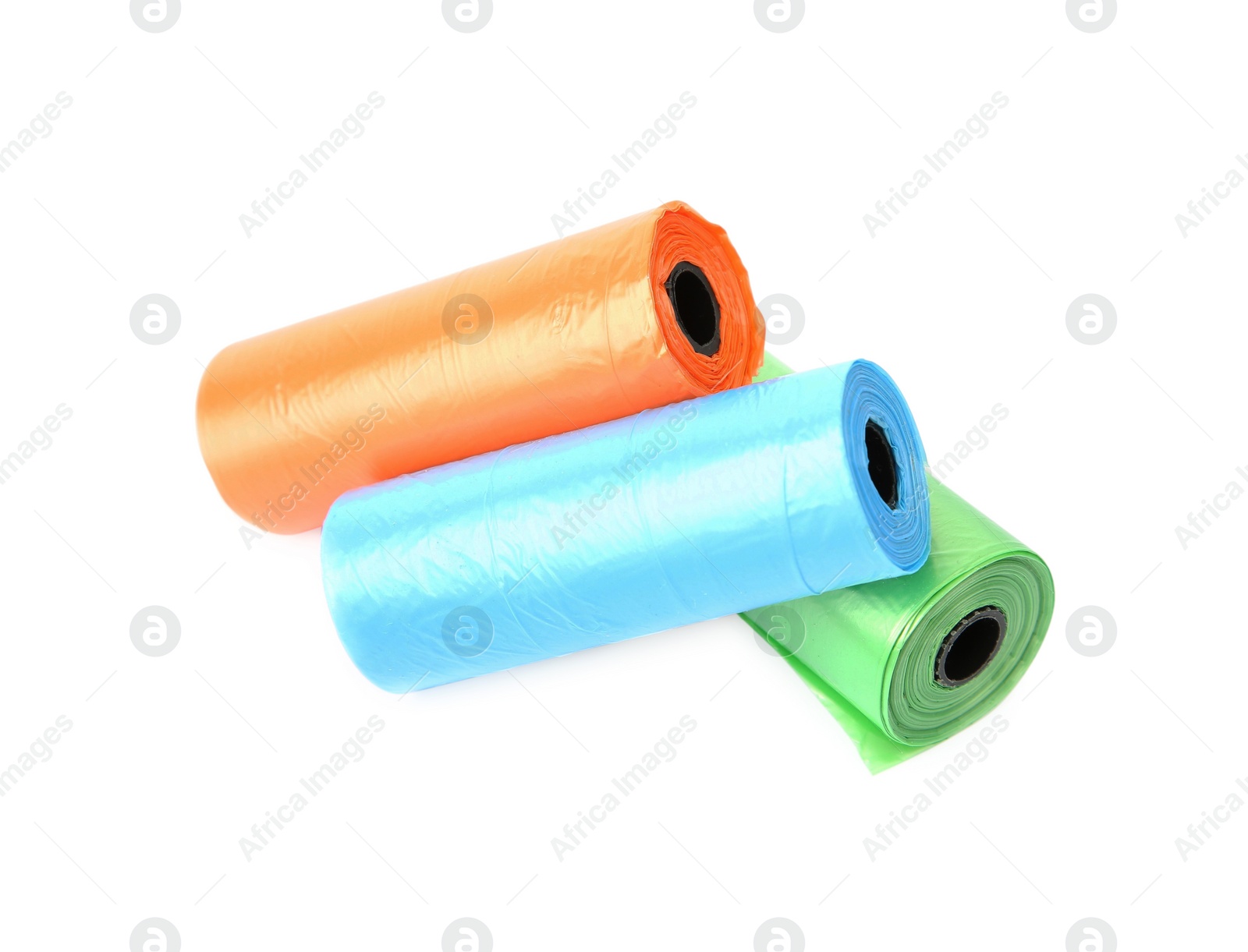 Photo of Rolls of colorful dog waste bags isolated on white