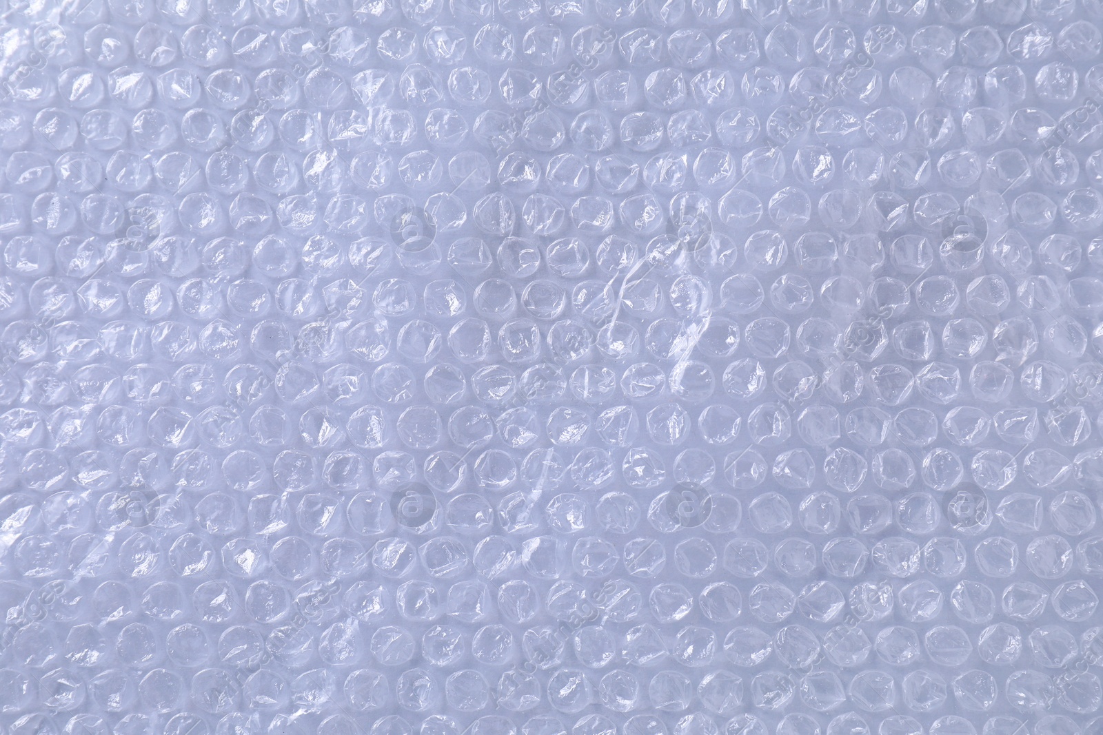 Photo of Transparent bubble wrap on gray background, top view