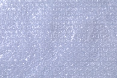 Photo of Transparent bubble wrap on gray background, top view