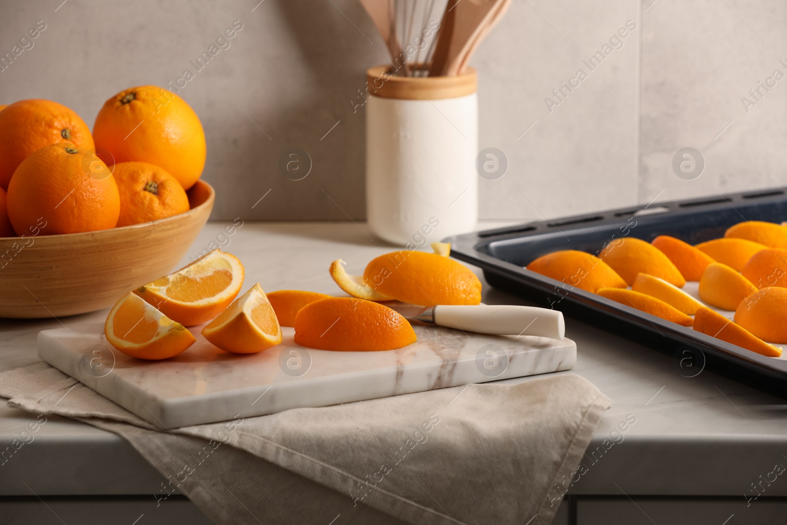 Photo of Fresh orange peels and juicy fruits on white table