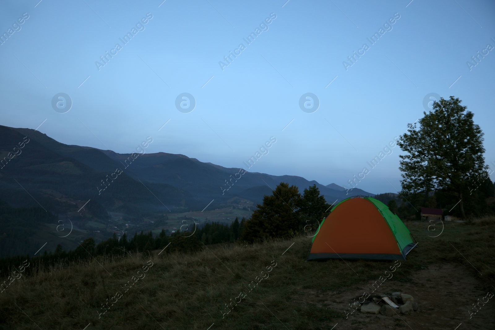 Photo of Camping tent on mountain slope in morning