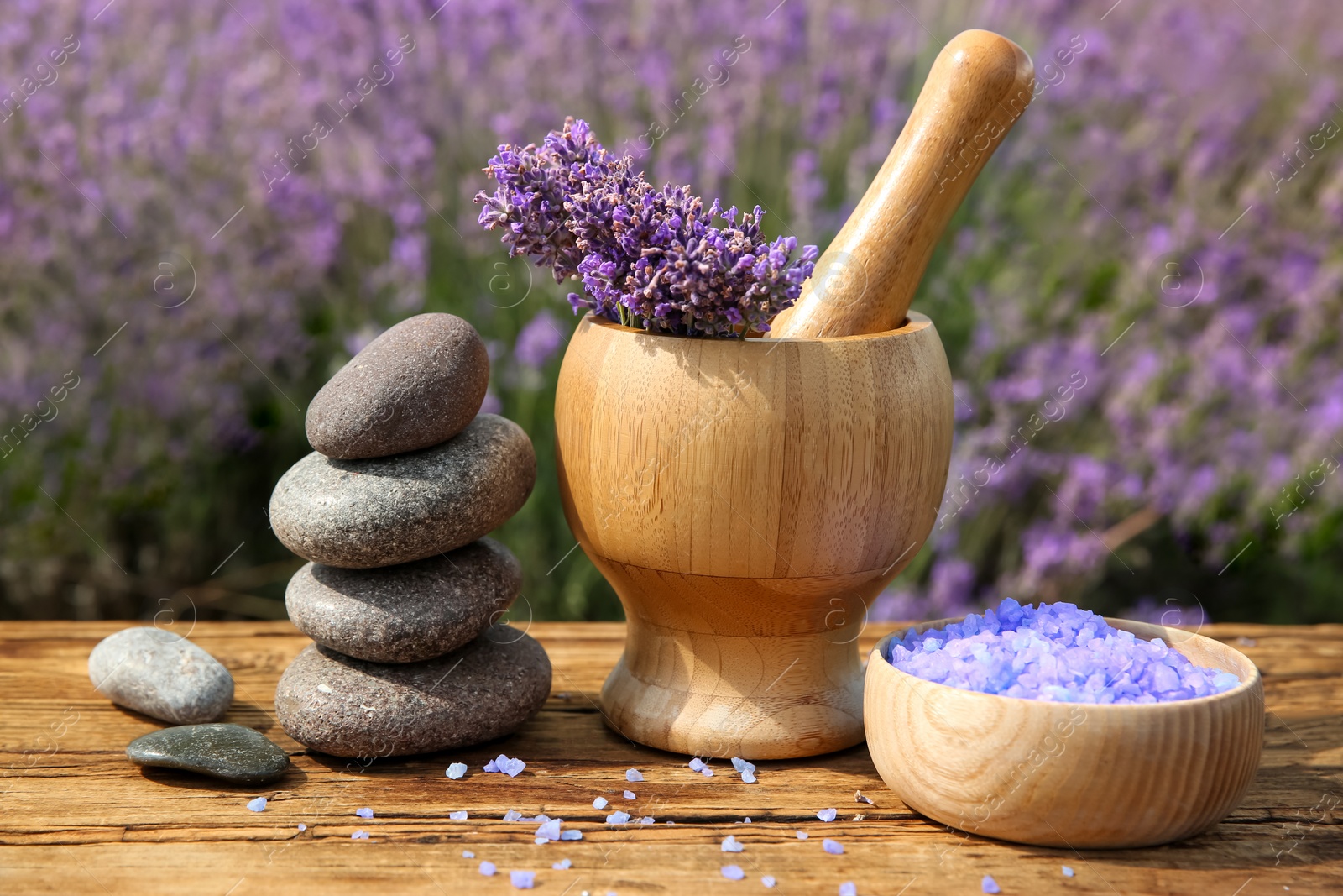 Photo of Spa composition with fresh lavender flowers on wooden table outdoors