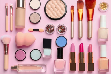 Photo of Flat lay composition with decorative cosmetics on color background