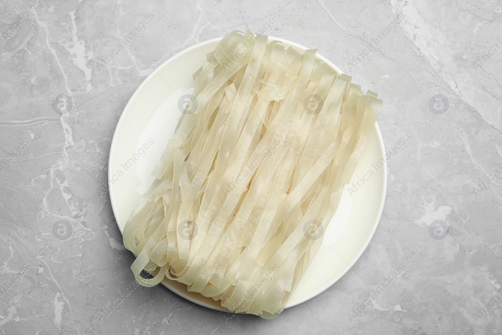 Photo of Block of rice noodles on light grey marble table, top view