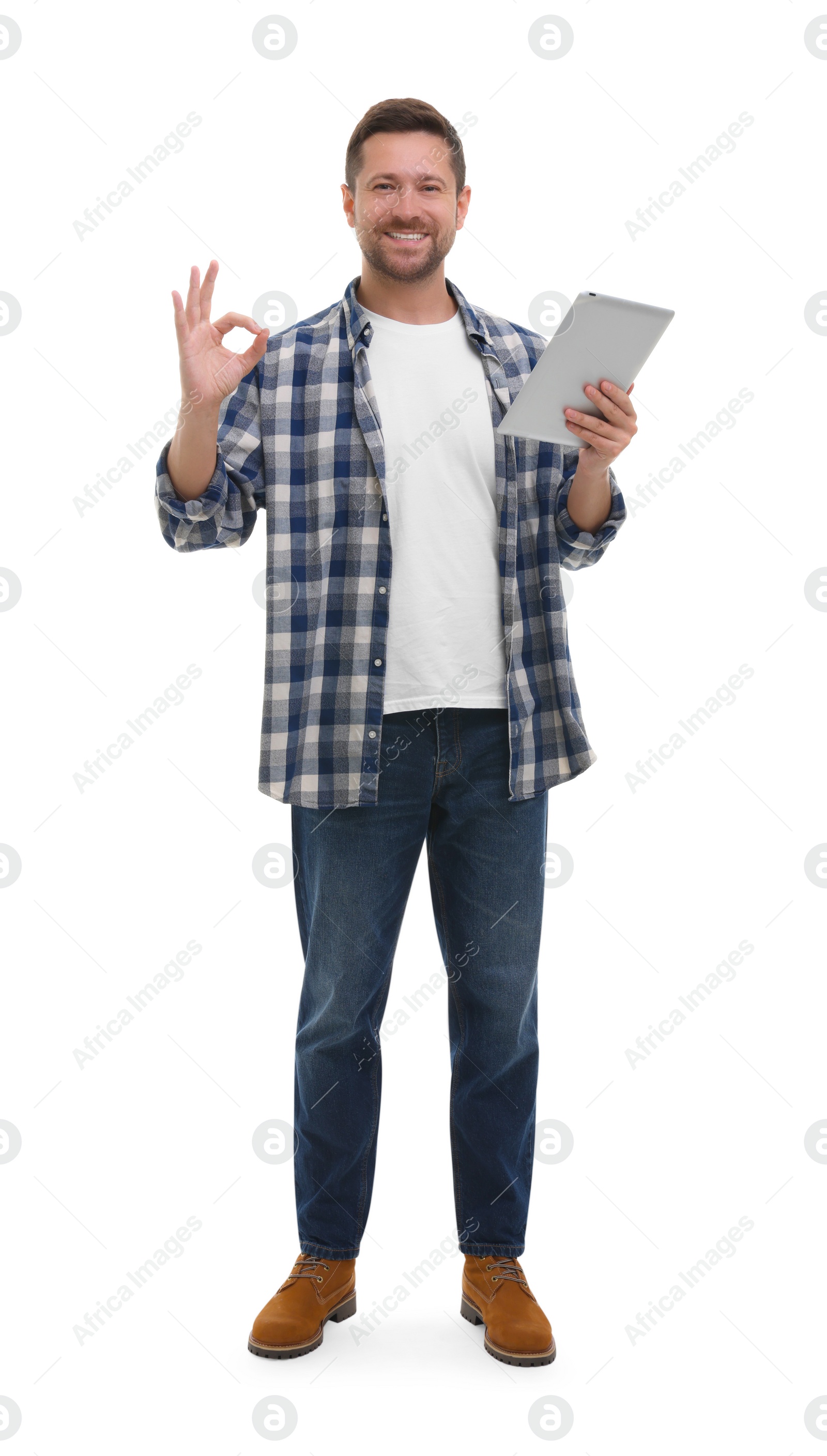 Photo of Happy man with tablet showing ok gesture on white background